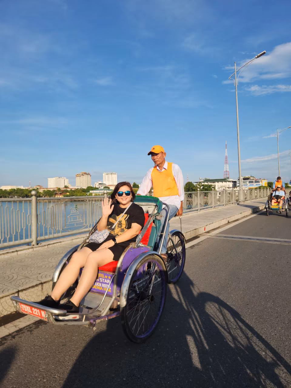 Cyclo crossing Truong Tien Bridge in Hue